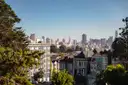 The downtown skyline seen over Victorian houses from Alamo Square