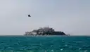 Alcatraz Island seen across open, choppy bay water