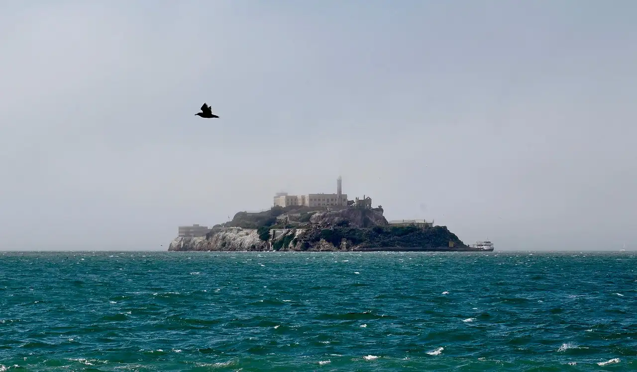 Alcatraz Island seen across open, choppy bay water