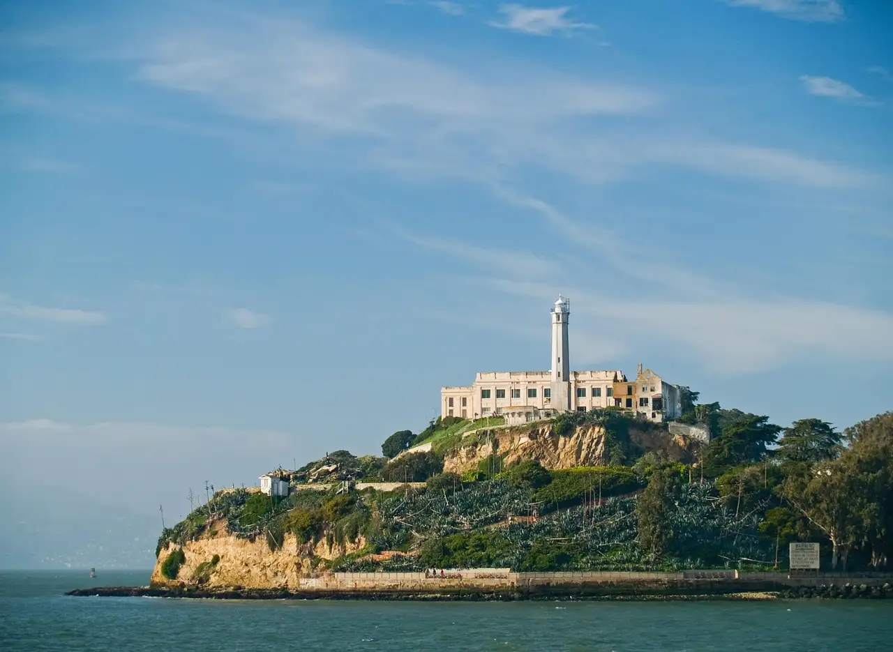 Alcatraz Island with its lighthouse and cellhouse, seen from the bay