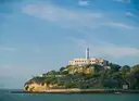 Alcatraz Island with its lighthouse and cellhouse, seen from the bay