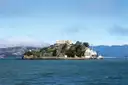 Alcatraz Island on a sunny day, seen from the bay