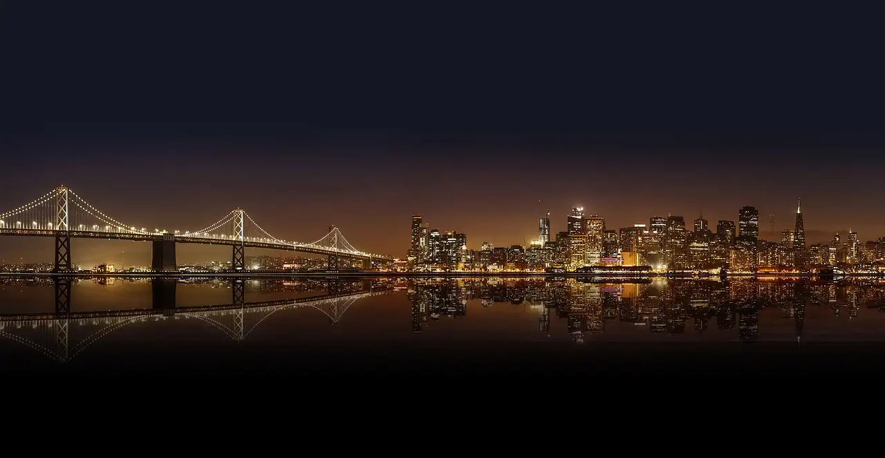 The Bay Bridge and the San Francisco skyline lit up at night