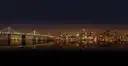 The Bay Bridge and the San Francisco skyline lit up at night