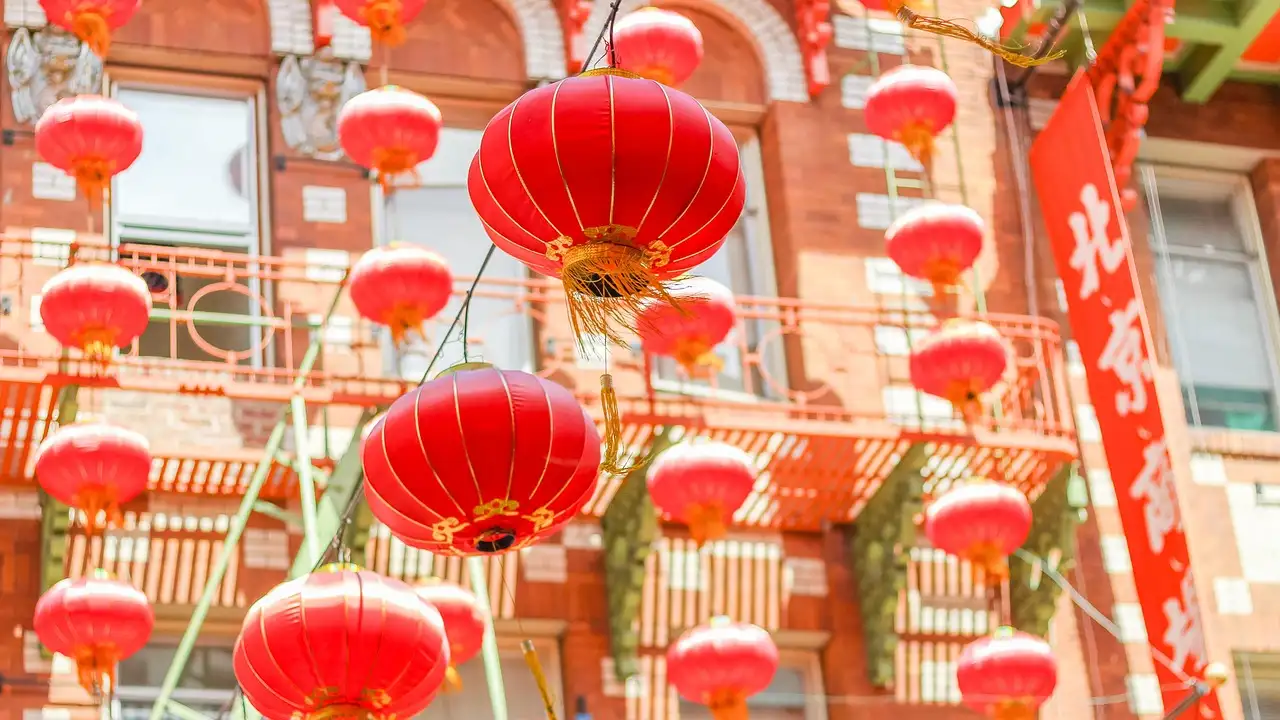 Red paper lanterns hanging across a street in San Francisco's Chinatown