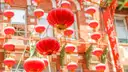 Red paper lanterns hanging across a street in San Francisco's Chinatown