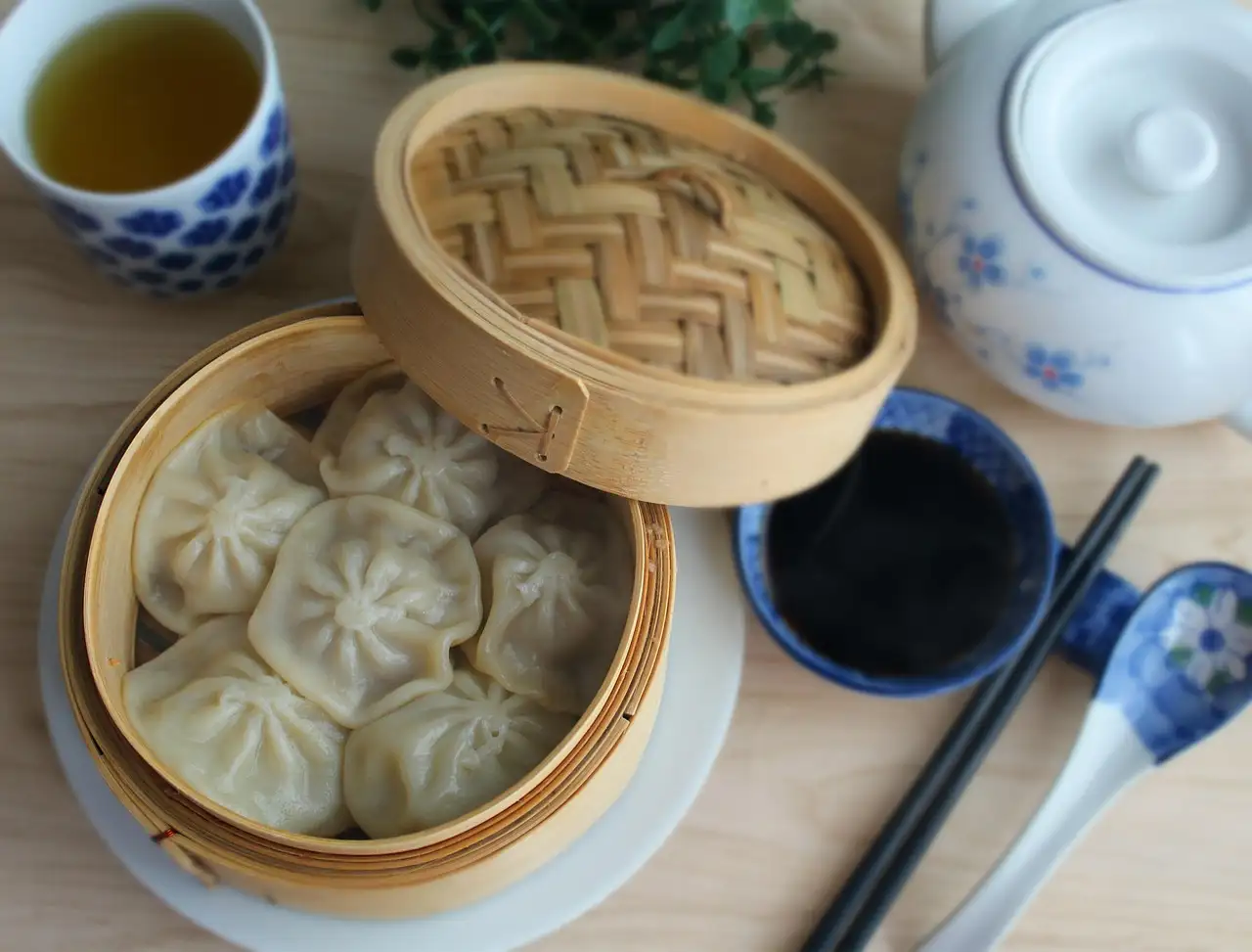 Steamed dim sum buns with tea and dipping sauce