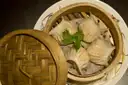 Shrimp dumplings in a bamboo steamer