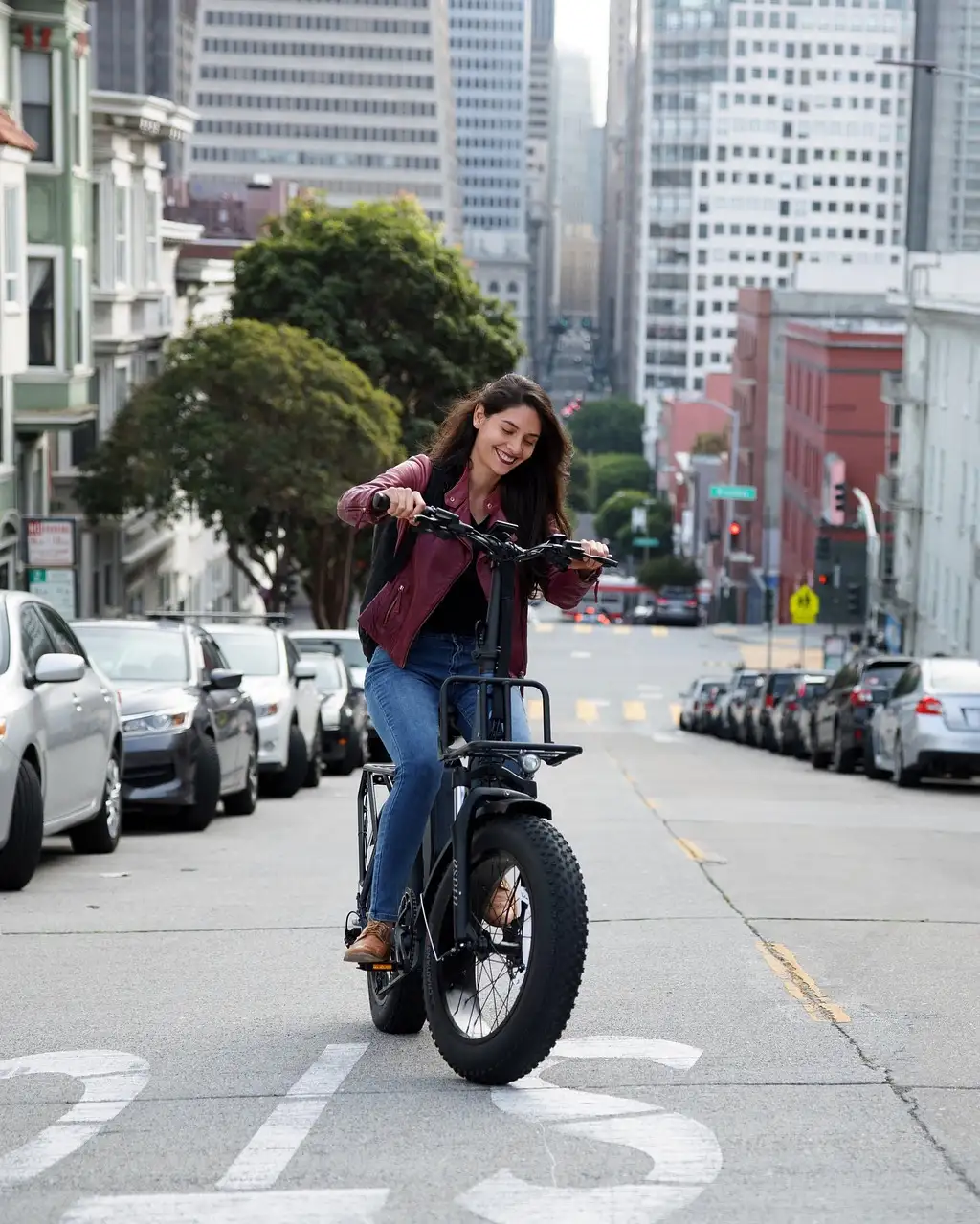 A rider on an e-bike on a steep downtown San Francisco street