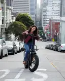 A rider on an e-bike on a steep downtown San Francisco street