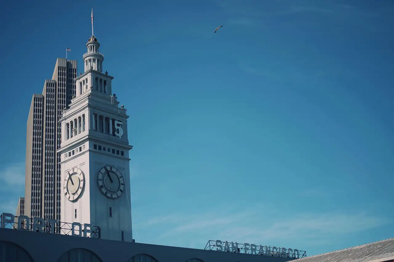 The clock tower of the Ferry Building on the San Francisco waterfront against a blue sky