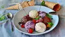 Scoops of gelato on a plate with waffle cones