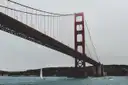 The Golden Gate Bridge seen from the water, with a sailboat beneath it