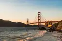 The Golden Gate Bridge at sunset from a beach