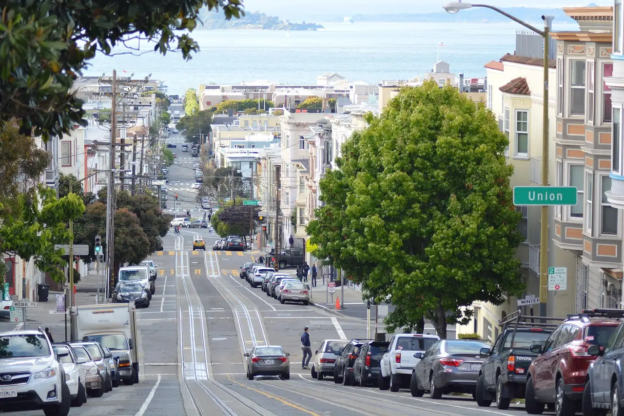 A busy residential street in San Francisco running downhill toward the bay