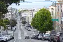 A busy residential street in San Francisco running downhill toward the bay