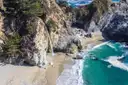 McWay Falls dropping onto the beach of a turquoise cove in Big Sur