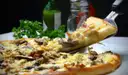 A slice of pizza being lifted from the pie