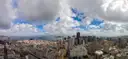 A wide panorama over San Francisco under big clouds