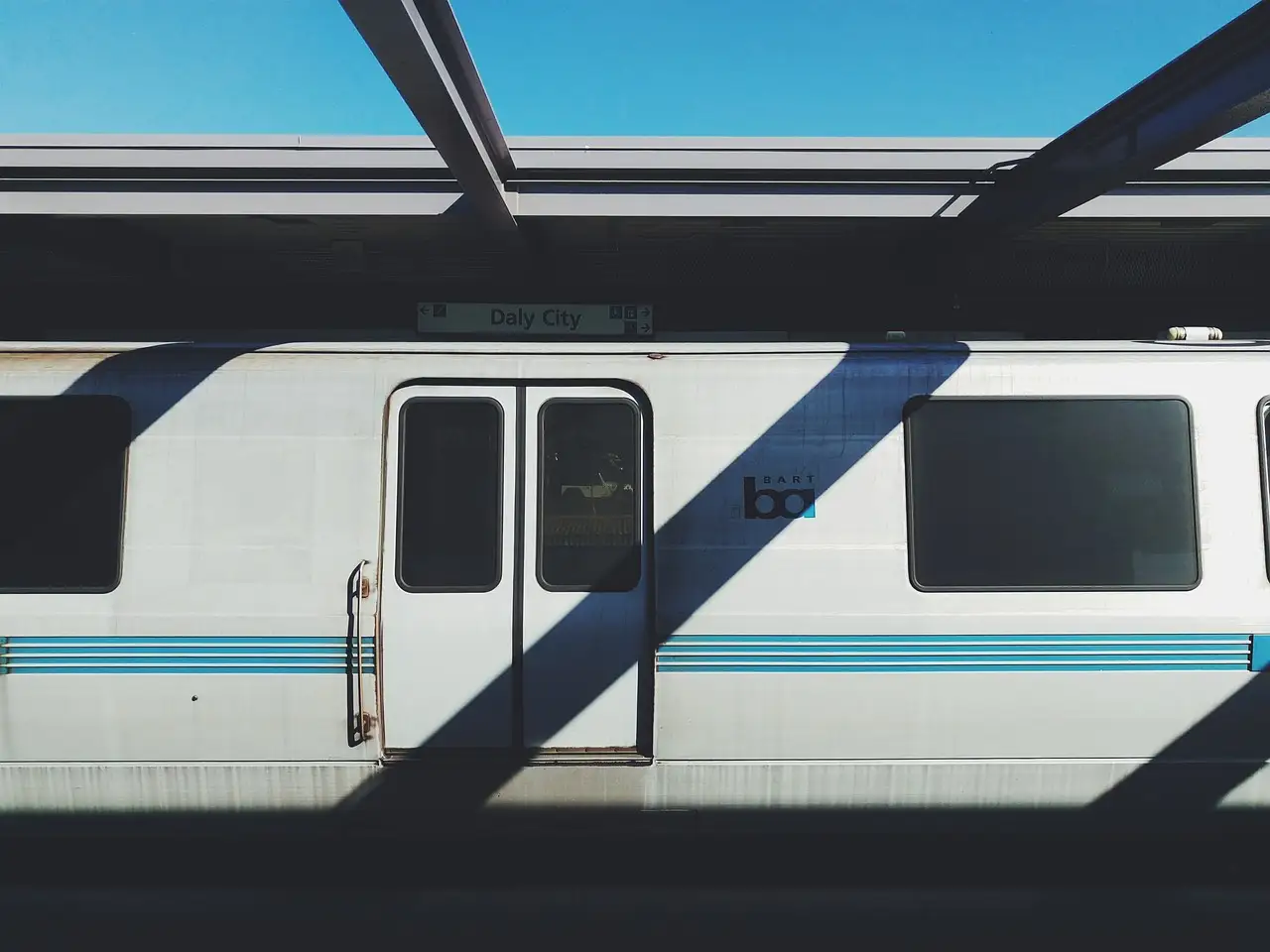 A BART train stopped at a station platform in the Bay Area