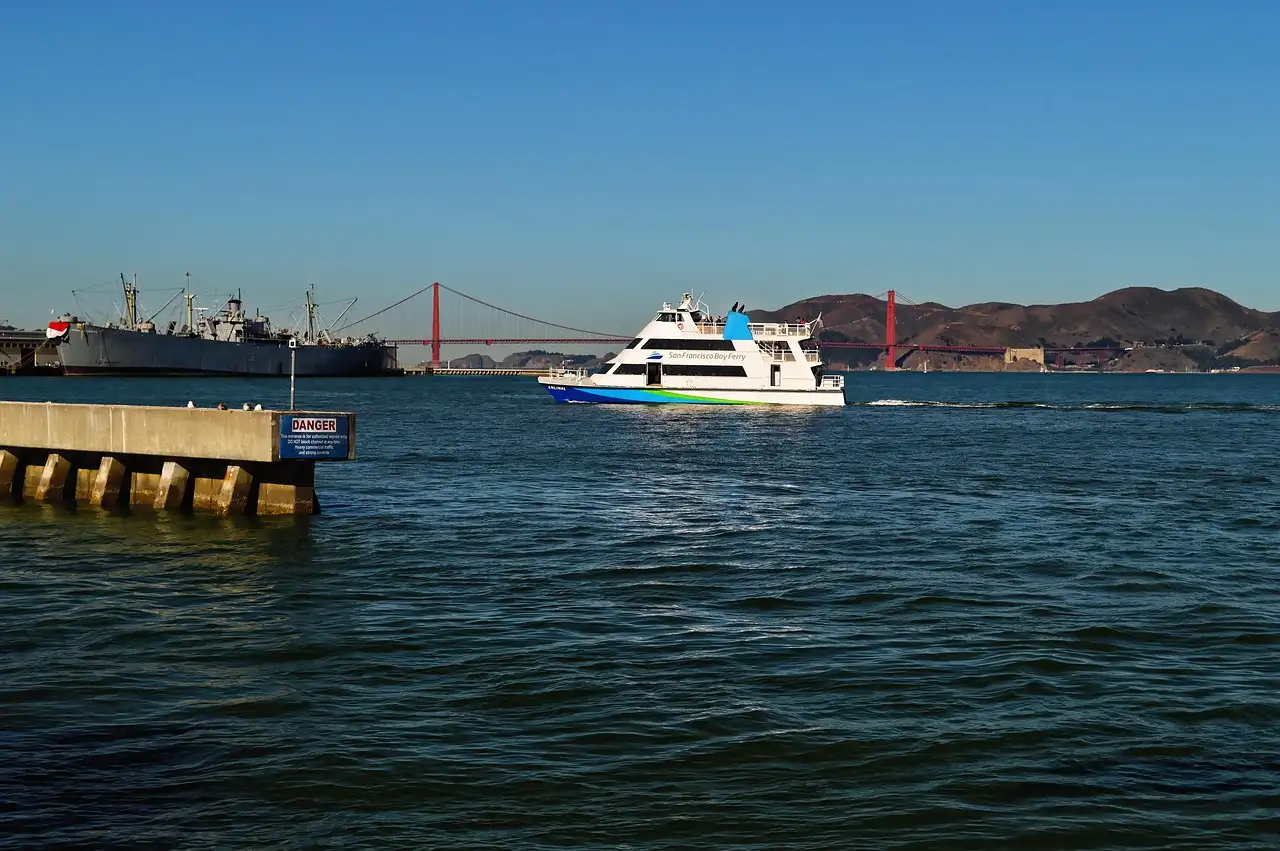 A sightseeing boat on San Francisco Bay with the Golden Gate Bridge behind it