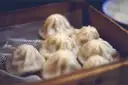 Soup dumplings in a bamboo steamer