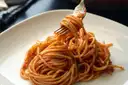 Spaghetti in tomato sauce twirled on a fork