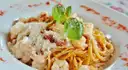 A plate of spaghetti with scampi and basil