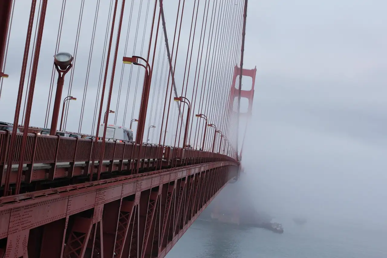 The Golden Gate Bridge fading into winter fog
