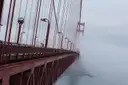 The Golden Gate Bridge fading into winter fog